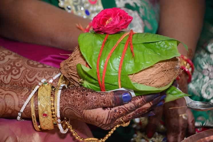 hindu bride holding a coconut