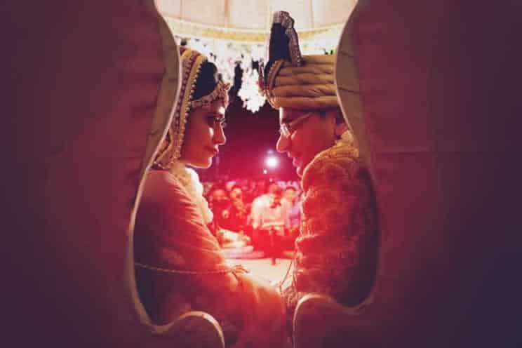 man and woman sitting on big chairs looking at each other