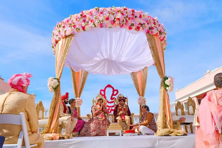 Outdoor Hindu wedding ceremony taking place