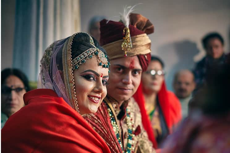 Hindu couple looking at camera at Indian wedding