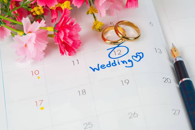 Calendar with wedding date marked along with two rings