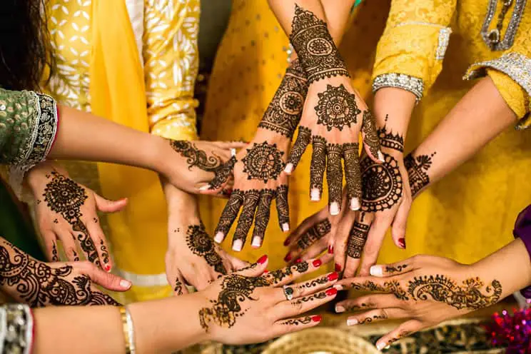 women with mehndi on their hands