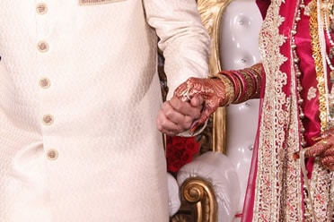 Hindu wedding couple holding hands at an Indian wedding