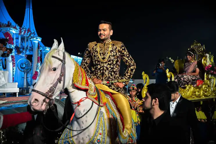 Hindu groom arriving on horseback