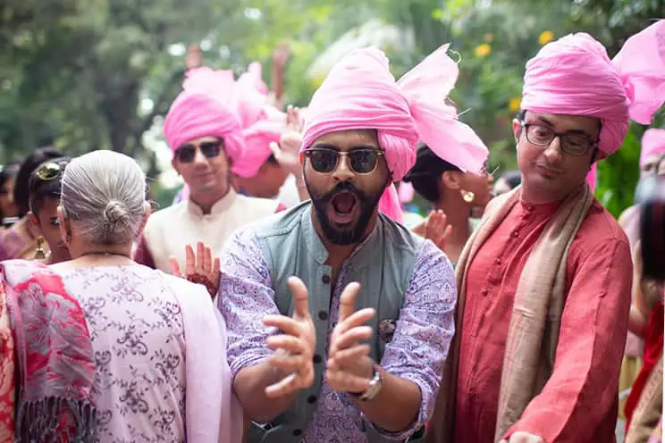 Hindu wedding guests wearing pink turbans