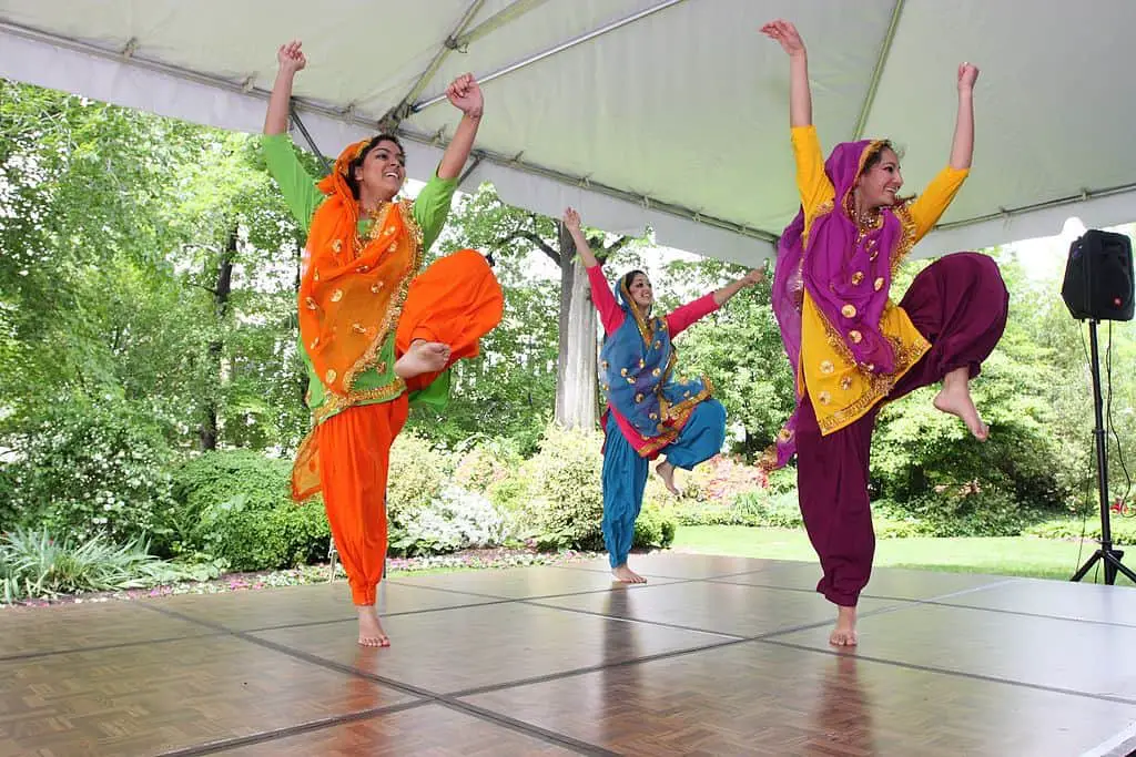 Women dancing on a stage for a Sangeet