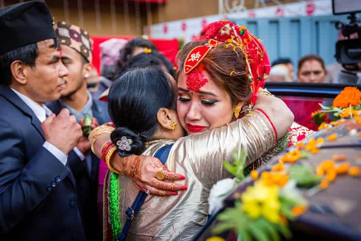 Indian bride embracing mother and crying